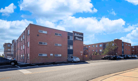 a large brick building with a sign on the side of a street