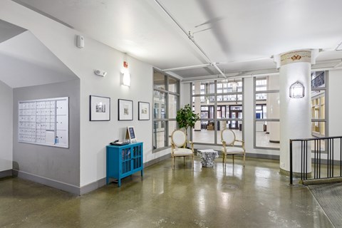 A room with a blue cabinet and a white wall with a calendar on it.