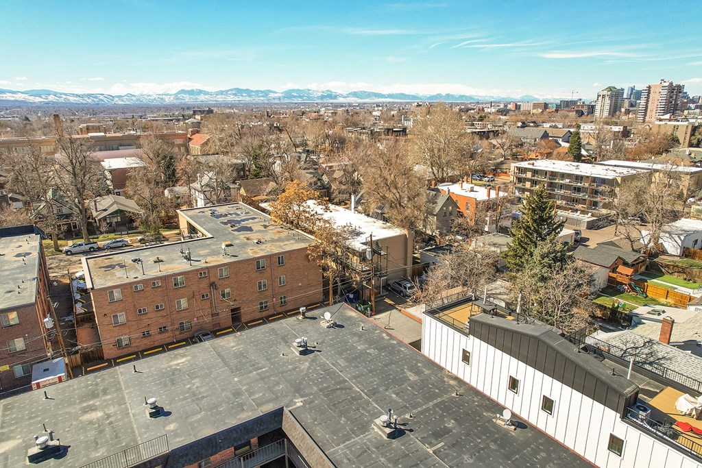 an aerial view of a city with buildings and trees