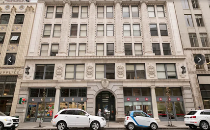 A white car is parked in front of a building with a sign that says "Supplies".