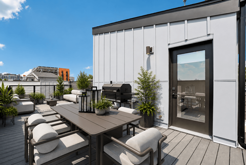 A patio with a table and chairs is set up outside a building.