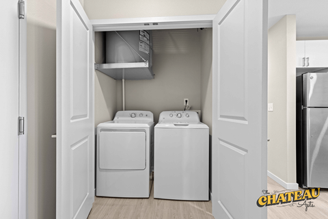 a washer and dryer in a laundry room with a refrigerator