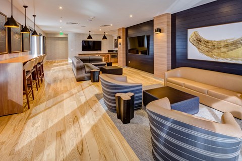 a hotel lobby with couches and chairs and a bar