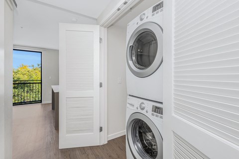 a white laundry room with a washer and a dryer