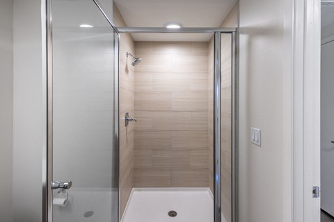 a bathroom with a shower and a sink in it