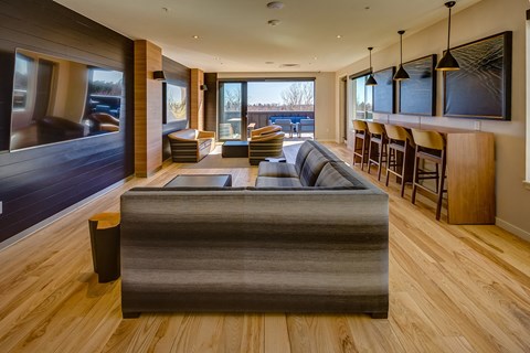 a large living room with a couch and a bar