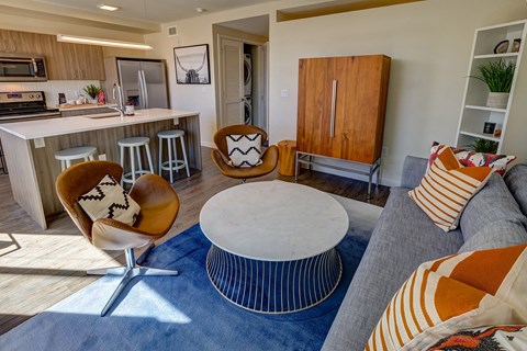 a living room and kitchen with a couch and a table