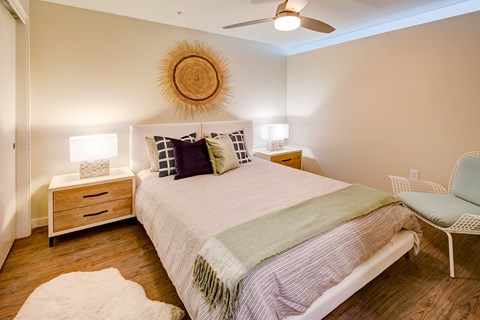 a bedroom with a bed and a ceiling fan