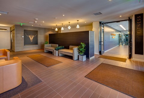 a lobby with couches and chairs and a reception desk
