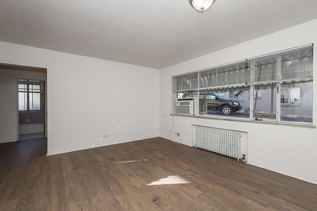 A room with a window and a radiator on the wall.