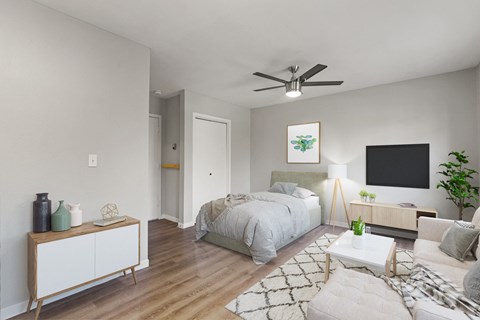 a bedroom with a large bed and a ceiling fan