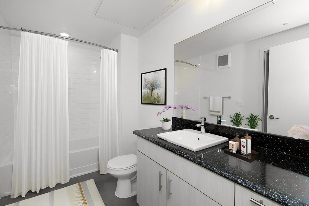 a white bathroom with a sink and a toilet