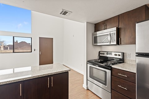 A kitchen with a stove, oven, and microwave.