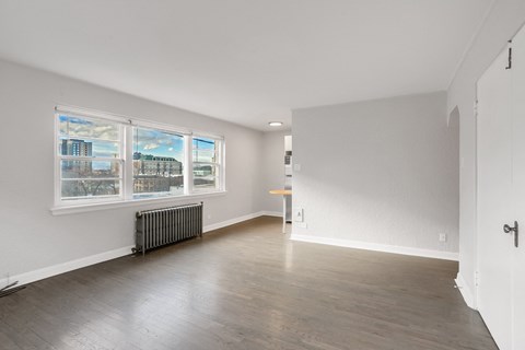 A room with a window and a radiator on the wall.