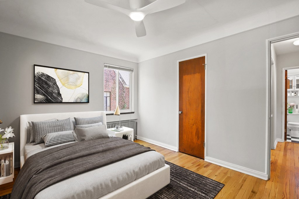 a bedroom with a bed and a ceiling fan