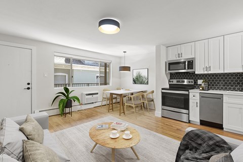 a living room with a couch and a table and a kitchen