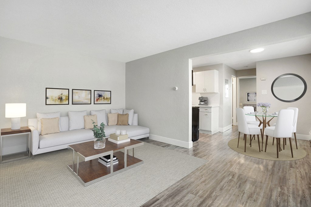 a living room and dining room with a table and a couch