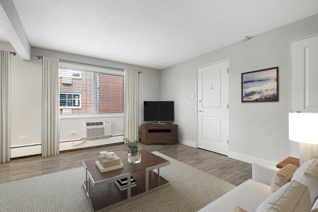 a living room with a couch and a coffee table and a television
