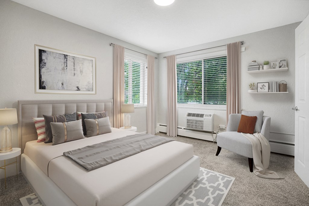 a bedroom with a bed and a chair and a window