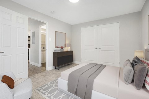 a bedroom with a large bed and a closet