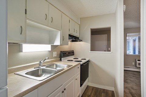 A kitchen with white cabinets and a black stove top oven.
