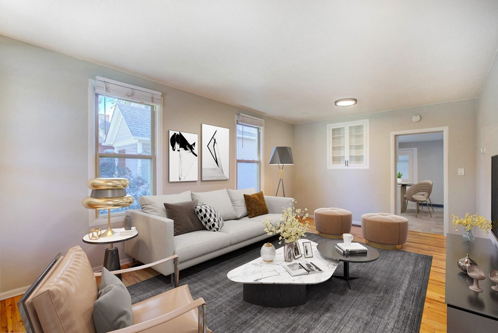 a living room with a white couch and a gray rug