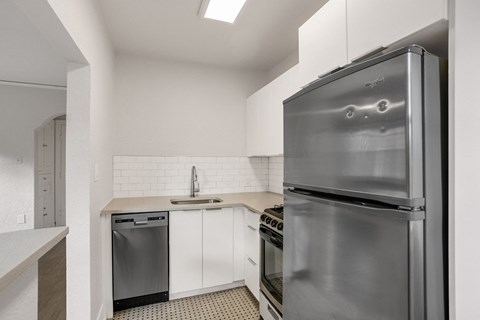 A modern kitchen with a stainless steel refrigerator.