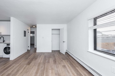 A room with a washing machine and a window.
