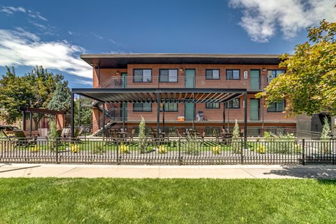 A large building with a balcony and a fence in front of it.