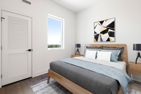 a bedroom with a bed and a window and a door