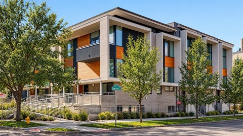 A modern building with a mix of beige and orange panels.