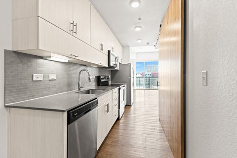a kitchen with white cabinets and stainless steel appliances