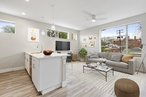 a living room with a couch and a table and a kitchen