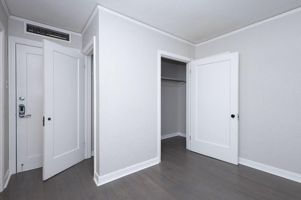 A room with three doors and a window.