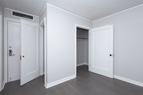 A room with three doors and a window.