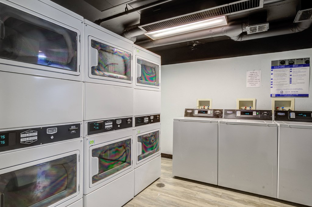 a row of microwaves in a room with other machines