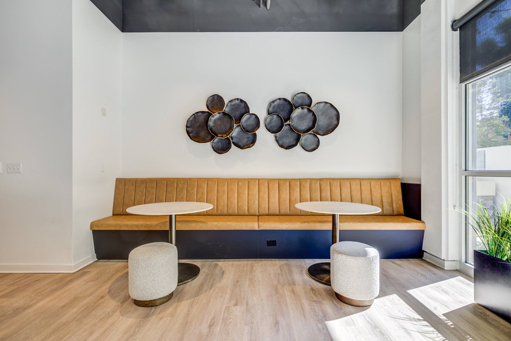 a living room with two tables and a couch and a window