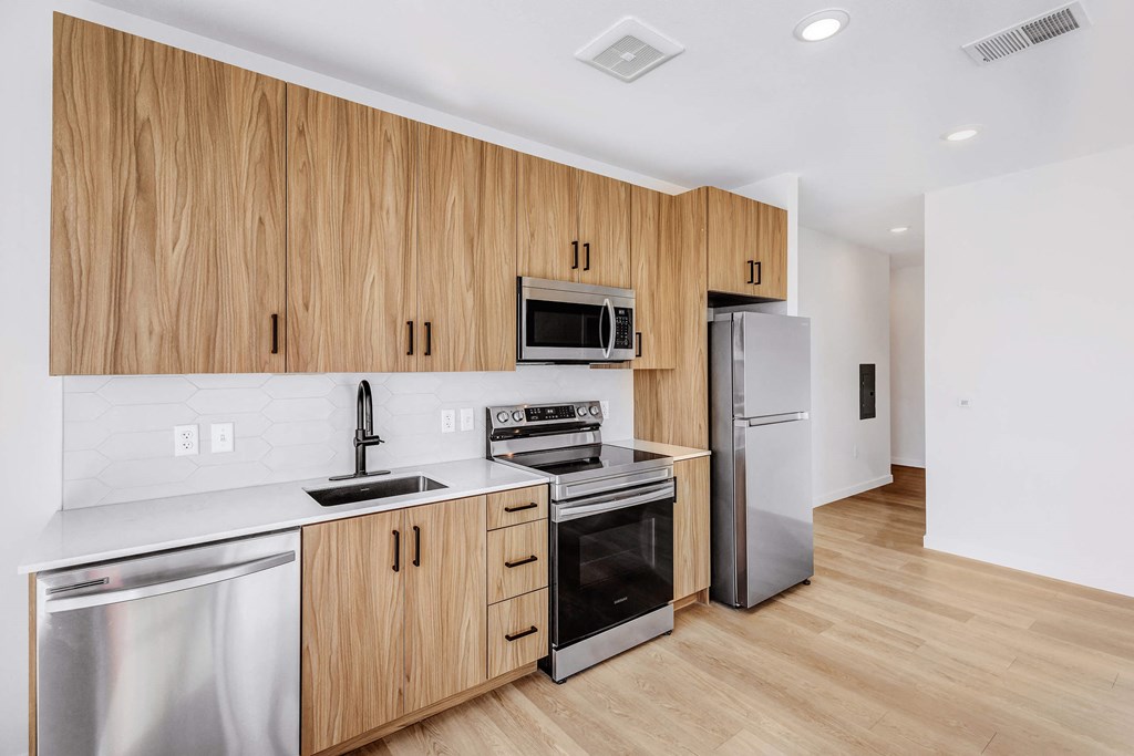 A kitchen with wooden cabinets and stainless steel appliances.