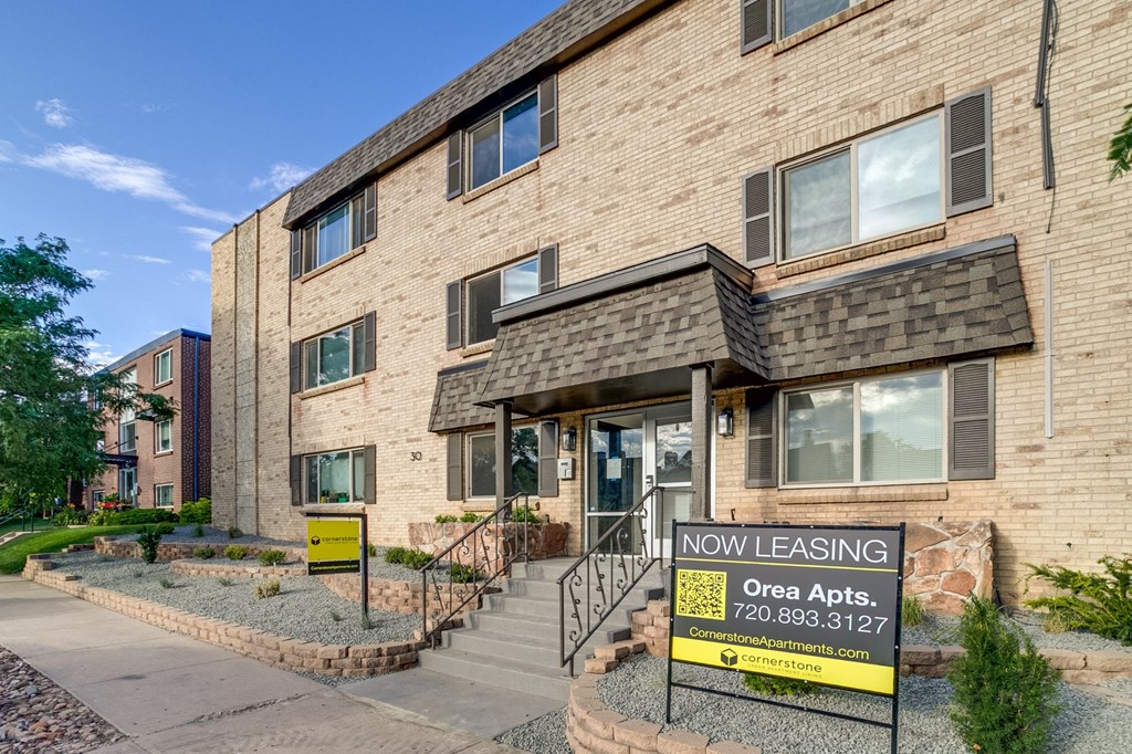 A building with a leasing sign in front of it.
