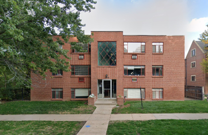 A red brick building with a glass window on the front.