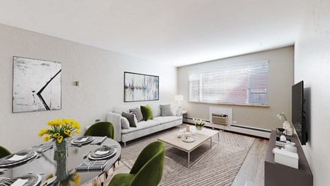 A living room with a couch, chairs, a coffee table, and a television.