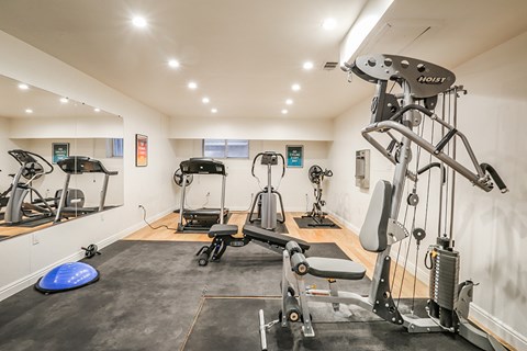 A gym with a variety of equipment including a leg press machine.