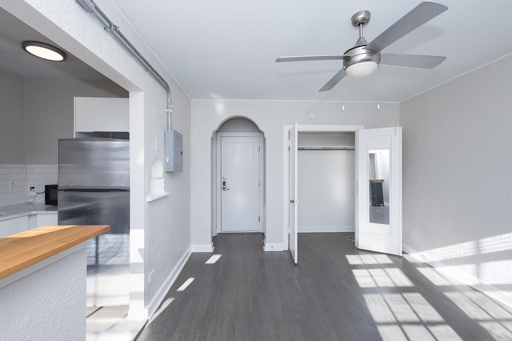 A modern kitchen with a fan on the ceiling.