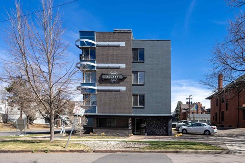 A modern apartment building with a sign that reads "BROOKLYN" on the front.