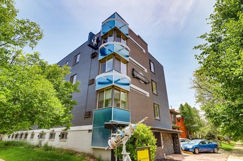 A modern building with a sculpture in front of it.