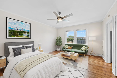 a bedroom with a bed and a ceiling fan