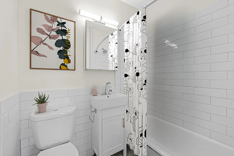 a white bathroom with a white toilet and a shower