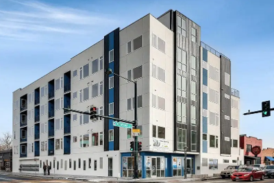 A modern multi-story building with a blue and white color scheme.