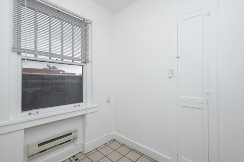 A white room with a window and a door.