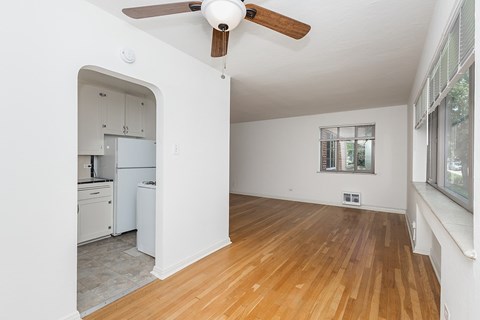 A room with a ceiling fan and a window.